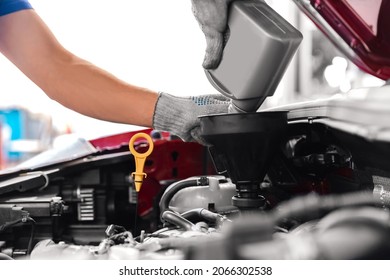 Mechanic Working On Checking And Service Car In Workshop Garage, Engine Oil Change.