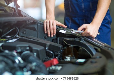 Mechanic working on engine in auto repair shop
 - Shutterstock ID 773491828