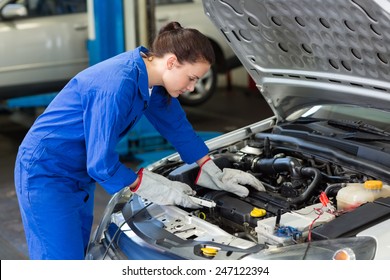 Mechanic Working Under The Hood At The Repair Garage