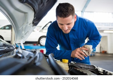 Mechanic Working Under The Hood At The Repair Garage