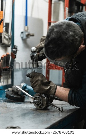 Mechanic working at workshop bench