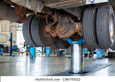 Mechanic Works With Rear Axle Reduction Gear Of Truck Maintenance Shop Service Station - Truck Service Technician Job.