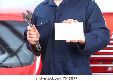 Mechanic With Wrench And Card. Auto Repair Shop.