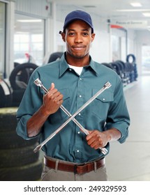 Mechanic with wrench in garage. Car repair service