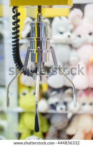A mechanical arm selecting a random soft toy in a vending machine.