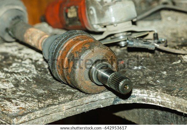 Mechanical automotive fixing engineering\
industry concept. Car joints in workshop. Vehicle elements\
disassembled to be\
repaired.