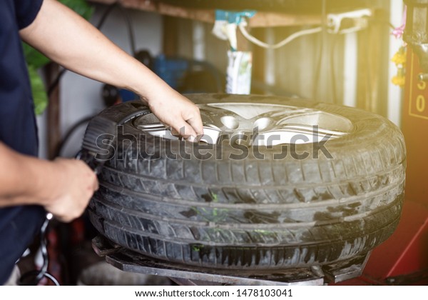 Mechanical car garage hand changing and\
replace car tire with mechanical stable\
engine