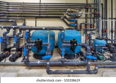 A Mechanical Electrical Pump Room Showing A Series Of Complex Pipe Works, Pumps And Valves