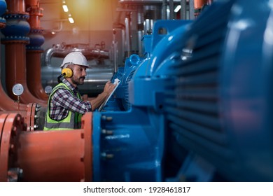 Mechanical Engineer Checking Of Centrifugal Pump In Pump Room. Worker Working In Plant Room.