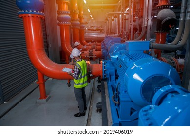 Mechanical Engineer Checking Of Centrifugal Pump In Pump Room. Worker Working In Plant Room.