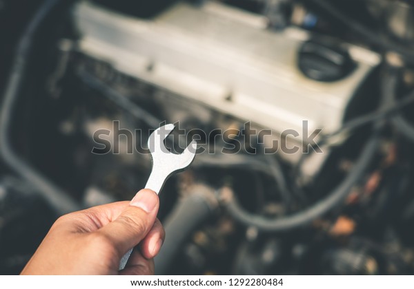 mechanical engineer hands open the car skirt to\
check the oil level of the car. The concept of engine maintenance\
Travel safely Caring for old\
cars