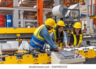 Mechanical engineer having a discussion with his trainees who are from different ethnicities and cultures over a production plan. Cooperation across cultures and races in a manufacturing system - Powered by Shutterstock