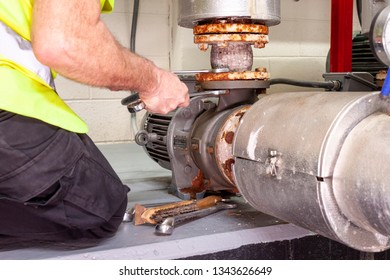 Mechanical Engineer In Hi Viz Vest Using Spanners To Removie An Expansion Joint