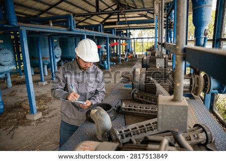 Mechanical Engineer Inspecting Pump Impeller During Industrial Equipment Maintenance at Water Plant