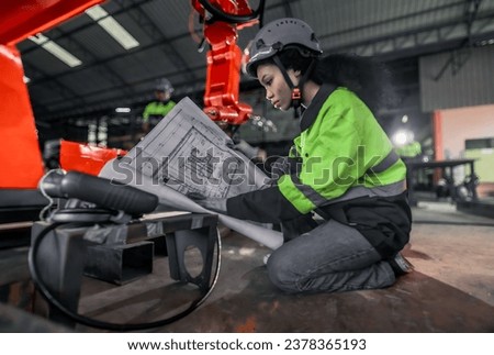 A mechanical engineer investigates the integration of silicon wafers onto printed circuit boards (PCBs) to optimize electrical signal communication, performance, energy efficiency of factory robot arm