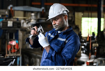 Mechanical engineer with safety hat checking and inspecting machine