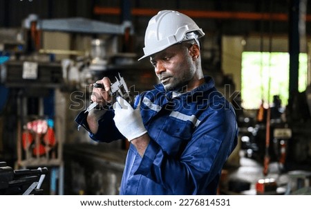 Mechanical engineer with safety hat checking and inspecting machine
