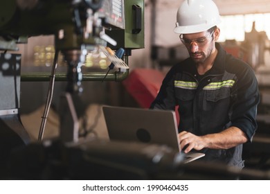 Mechanical engineer using the laptop computer and working for maintenance or repairing the machine in factory. Maintenance and repairing work in modern industry concept. - Powered by Shutterstock