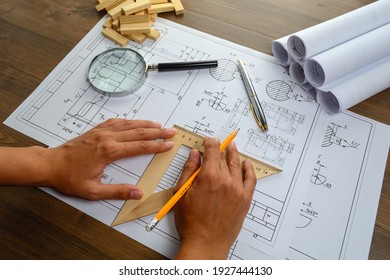 Mechanical engineer at work. Technical drawings. Paper with technical drawings and diagrams.