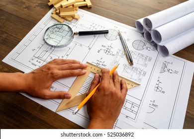 Mechanical engineer at work. Technical drawings. Paper with technical drawings and diagrams. - Shutterstock ID 525036892