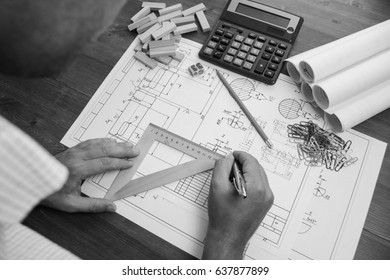 Mechanical engineer at work. Technical drawings. Paper with technical drawings and diagrams.