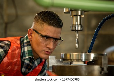 Mechanical engineer working on machines at factory.