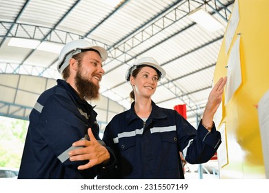 Mechanical engineers repairing engine machine at factory