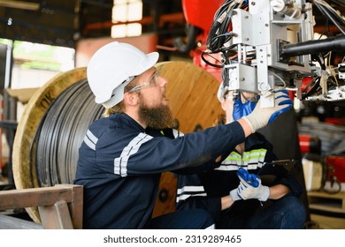 Mechanical engineers repairing engine machine at factory
