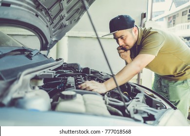 Mechanical Fixing Car At Home. Repairing Service Advice By Mobile Phone. Mechanic, Technician Man Checking Car Engine. Car Service, Repair, Fixing, Maintenance Working Inspection Vehicle Concept.