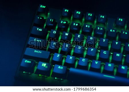 A mechanical gaming keyboard with green backlight. 