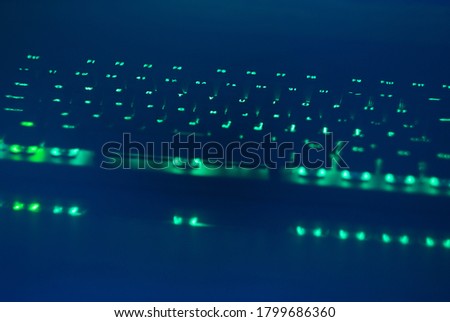 A mechanical gaming keyboard with green backlight. 