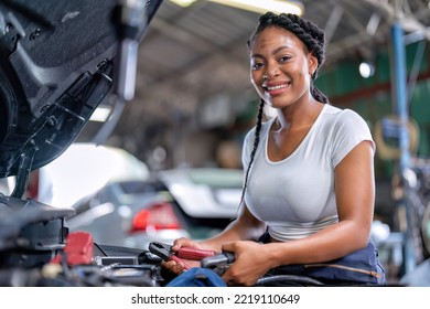 Mechanical Girl At Car Repair Shop Stand Hold Battery Jumper Cable Red And Black For Polarity Negative And Positive DC Volt