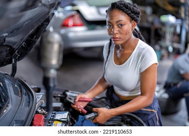 Mechanical Girl At Car Repair Shop Stand Hold Battery Jumper Cable Red And Black For Polarity Negative And Positive DC Volt