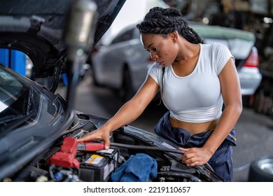 Mechanical Girl At Car Repair Shop Stand Hold Battery Jumper Cable Red And Black For Polarity Negative And Positive DC Volt