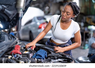 Mechanical Girl At Car Repair Shop Stand Hold Battery Jumper Cable Red And Black For Polarity Negative And Positive DC Volt