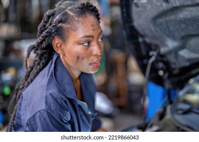 Mechanical girl dirty face wearing overall cover suit checking pressure vacuum gauge during car refrigerator gas charging at garage shop - Powered by Shutterstock