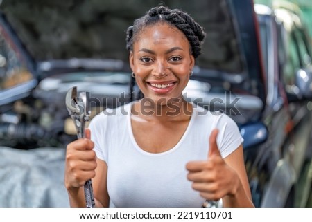 Mechanical guy at car repair shop stand smiling to camera portrait