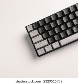 mechanical keyboard with black gray and orange keycaps on a minimalist white background