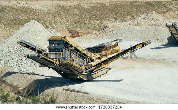 Mechanical\
machine, conveyor belt for transporting and crushing stone with\
sand. Mining quarry for the production of crushed stone, sand and\
gravel for use in the construction\
industry.