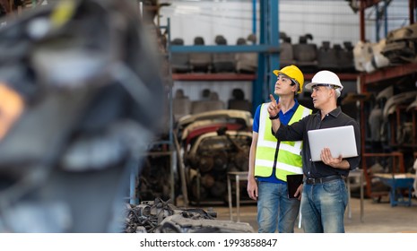 Mechanical Man Owner Small Business Inspecting Old Car Parts Stock On Laptop Computer While Working In Old Automobile Parts Large Warehouse