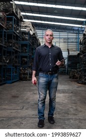 Mechanical Man Owner Small Business Inspecting Old Car Parts Stock On Laptop Computer While Working In Old Automobile Parts Large Warehouse