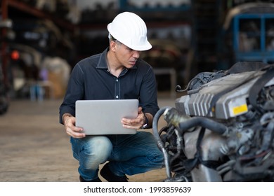 Mechanical Man Owner Small Business Inspecting Old Car Parts Stock On Laptop Computer While Working In Old Automobile Parts Large Warehouse