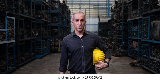 Mechanical Man Owner Small Business Inspecting Old Car Parts Stock On Laptop Computer While Working In Old Automobile Parts Large Warehouse