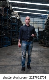 Mechanical Man Owner Small Business Inspecting Old Car Parts Stock On Laptop Computer While Working In Old Automobile Parts Large Warehouse