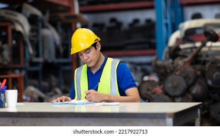 Mechanical Man Owner Small Business Inspecting Old Car Parts Stock On Laptop Computer While Working In Old Automobile Parts Large Warehouse