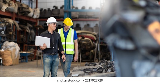 Mechanical Man Owner Small Business Inspecting Old Car Parts Stock On Laptop Computer While Working In Old Automobile Parts Large Warehouse