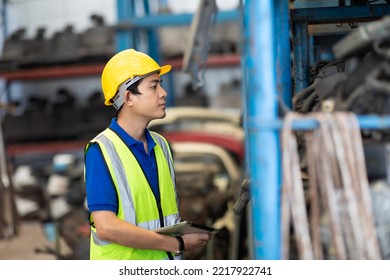 Mechanical Man Owner Small Business Inspecting Old Car Parts Stock On Laptop Computer While Working In Old Automobile Parts Large Warehouse