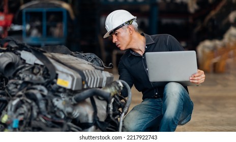 Mechanical Man Owner Small Business Inspecting Old Car Parts Stock On Laptop Computer While Working In Old Automobile Parts Large Warehouse