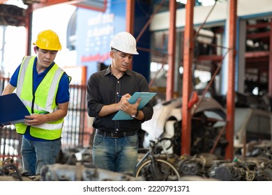 Mechanical Man Owner Small Business Inspecting Old Car Parts Stock On Laptop Computer While Working In Old Automobile Parts Large Warehouse