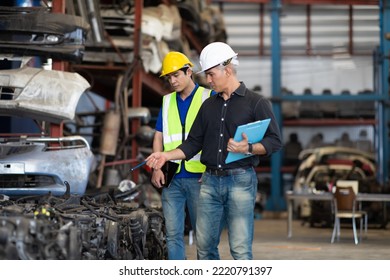 Mechanical Man Owner Small Business Inspecting Old Car Parts Stock On Laptop Computer While Working In Old Automobile Parts Large Warehouse